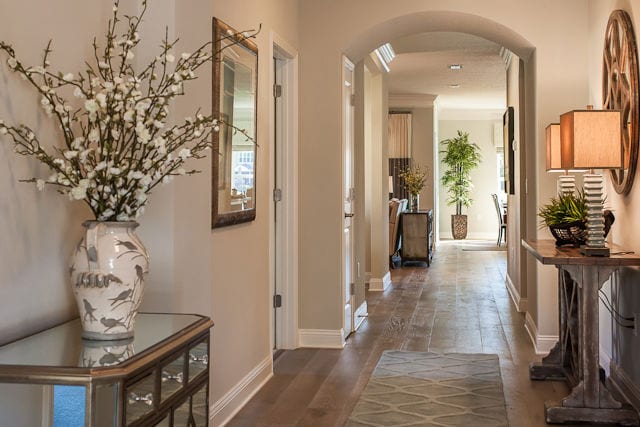 Wide angle of a hallway leading into the living room