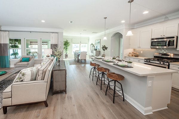 Wide angle of a kitchen looking into the dining and living area